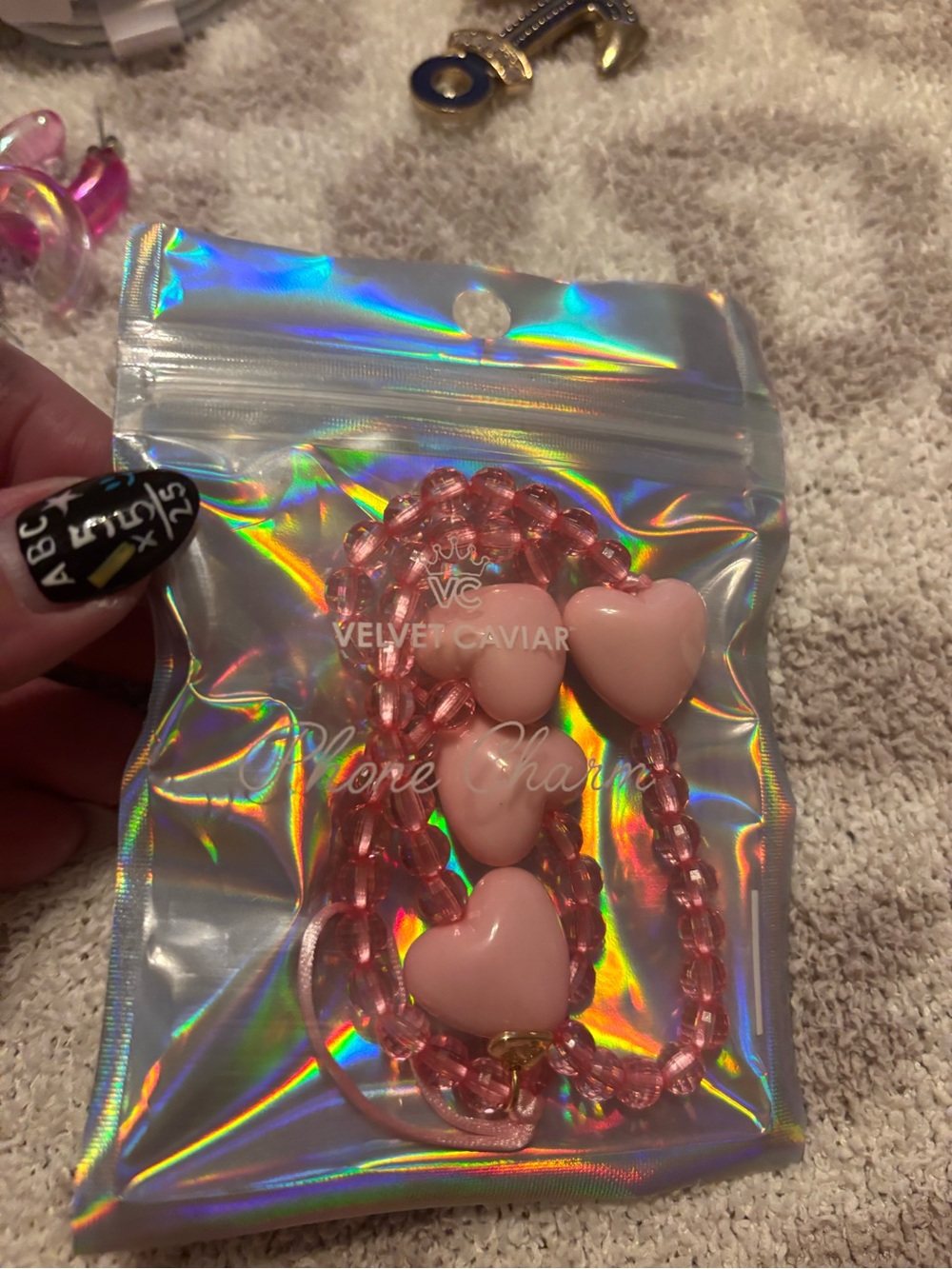 Velvet Caviar heart phone chain